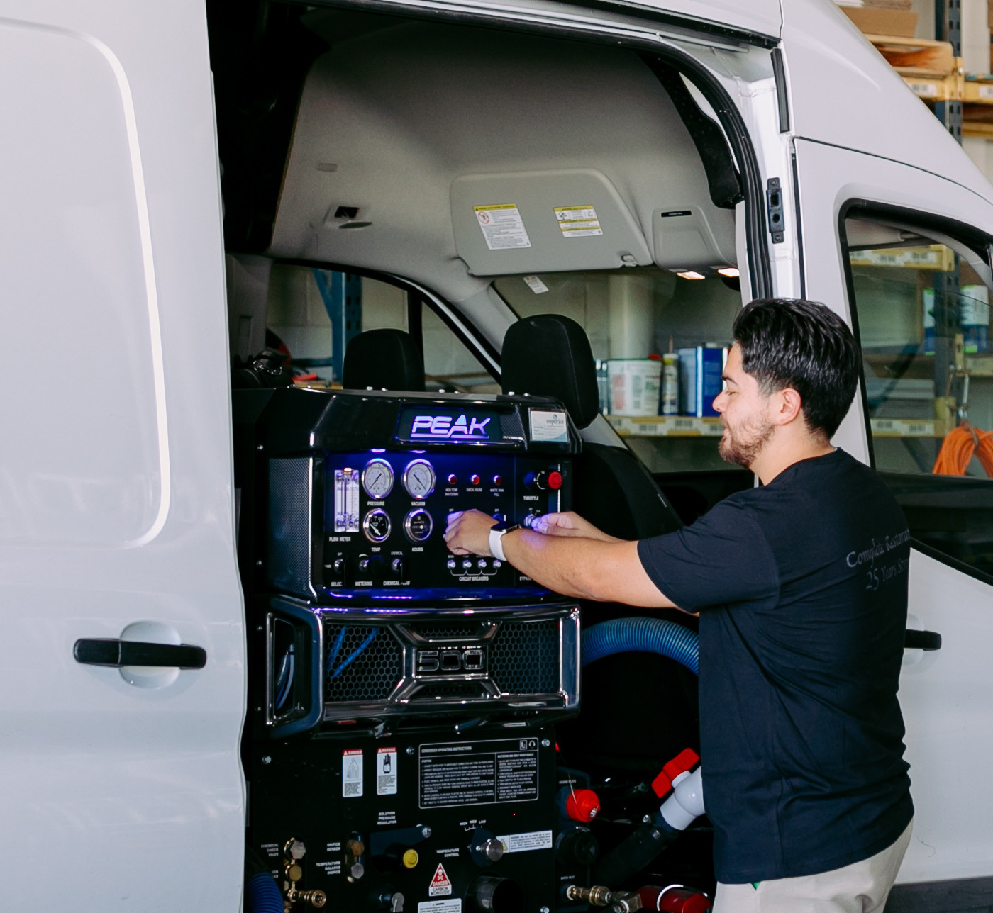 Complete Restoration specialist operating truck-mounted extraction equipment for flood cleanup