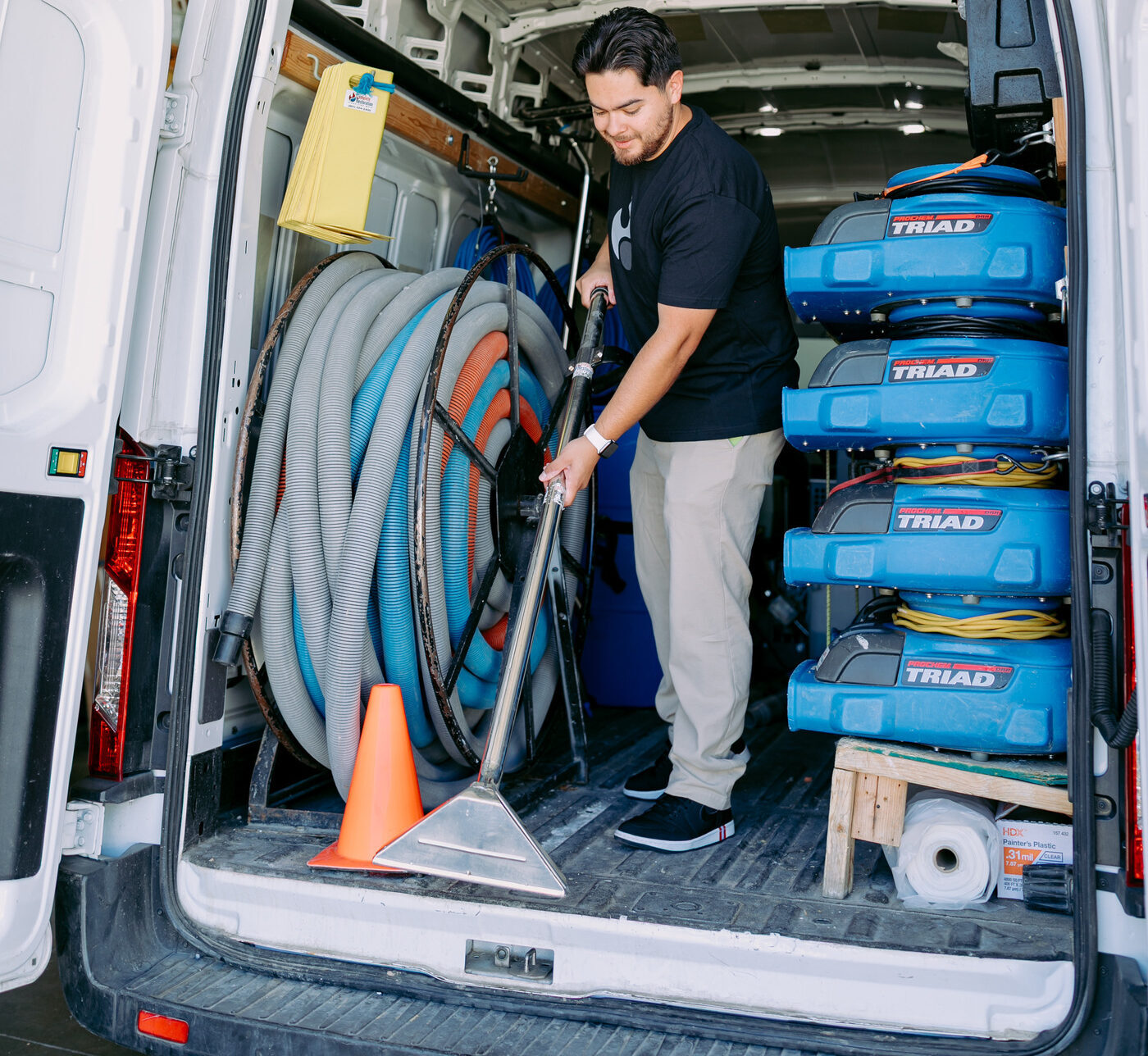 Restoration technician preparing industrial air movers for emergency water damage drying in Utah