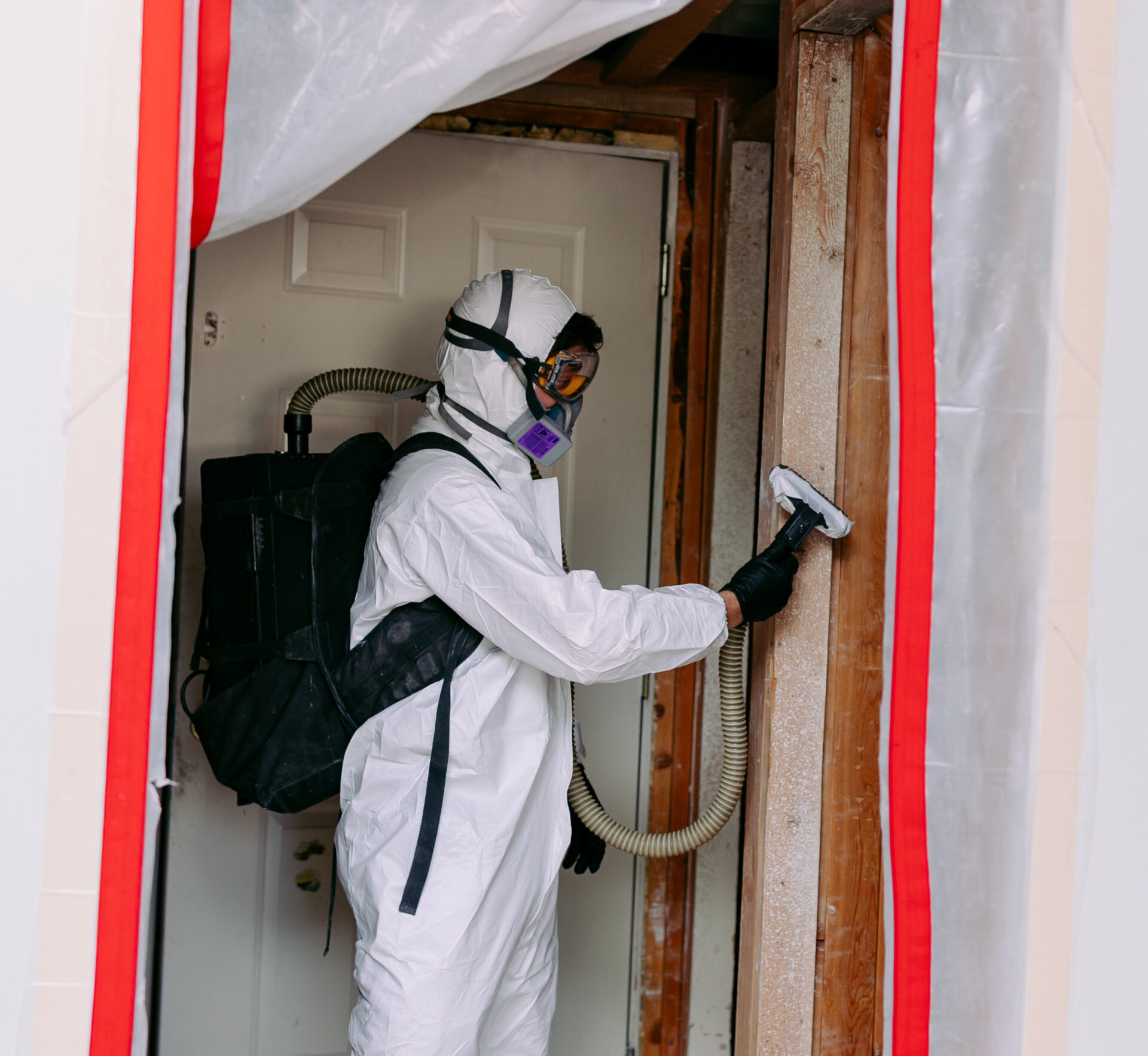 Certified mold remediation technician using HEPA vacuum and containment for safe spore removal